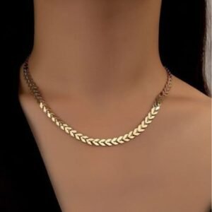 Gold finish herringbone chain necklace worn by woman