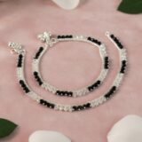 Elegant black beaded silver anklet for women with minimalist design worn on feet
