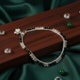 Elegant black beaded silver anklet for women with minimalist design worn on feet