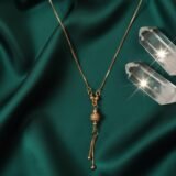 Gold plated drop pendant necklace with textured ball charm and tassel chain for women