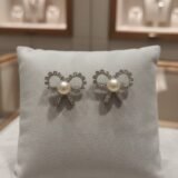 Luxury pearl bow stud earrings with zircon crystal detailing and silver-tone finish for women