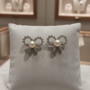 Luxury pearl bow stud earrings with zircon crystal detailing and silver-tone finish for women